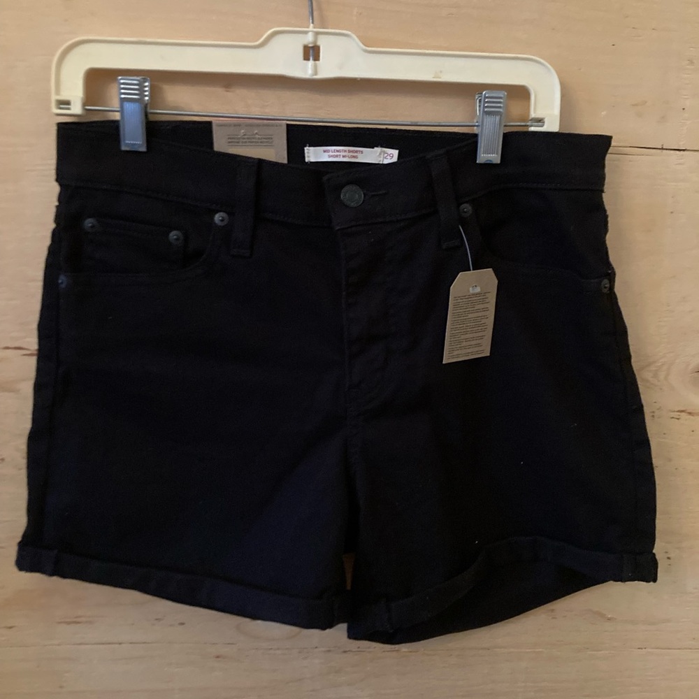 Black Levi’s jean shorts. Mid-length, mid-rise, slim through the hip. Size 29.